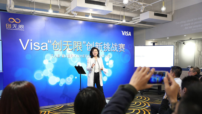 Woman gives speech at China's Visa Everywhere Initiative competition.