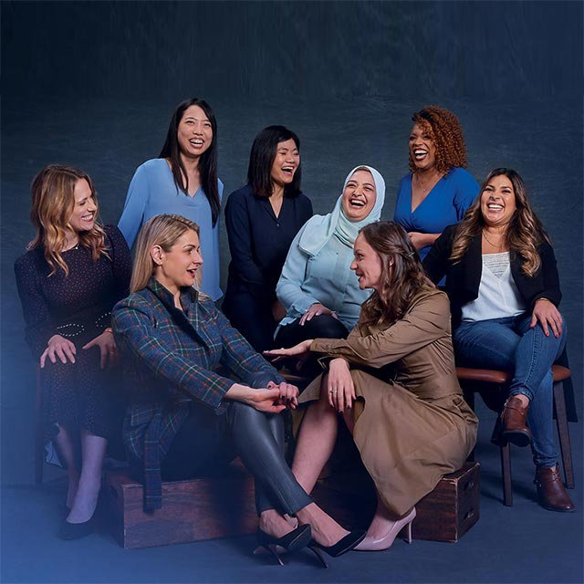 women entrepreneurs seated together laughing