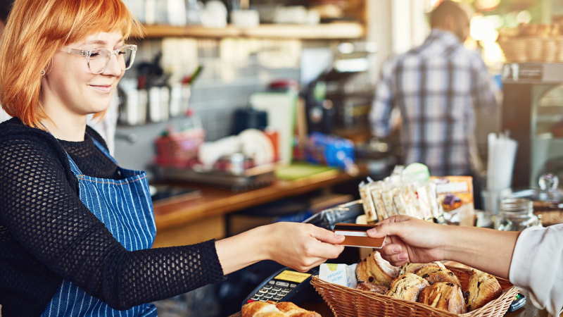 woman in shop using card