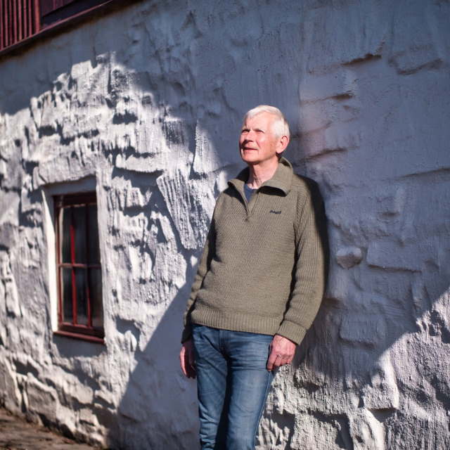 Man leaning against house