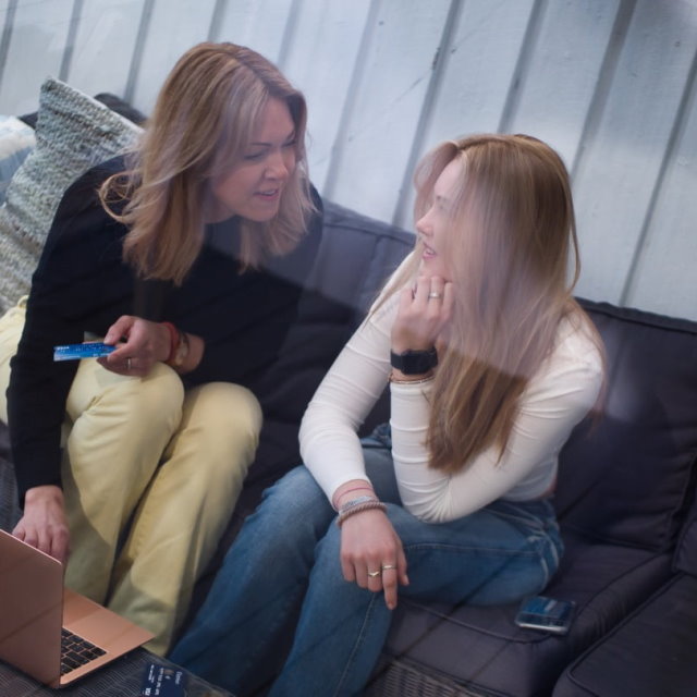 Mother and daughter using laptop