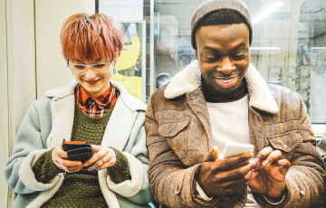 two people next to each other on phone