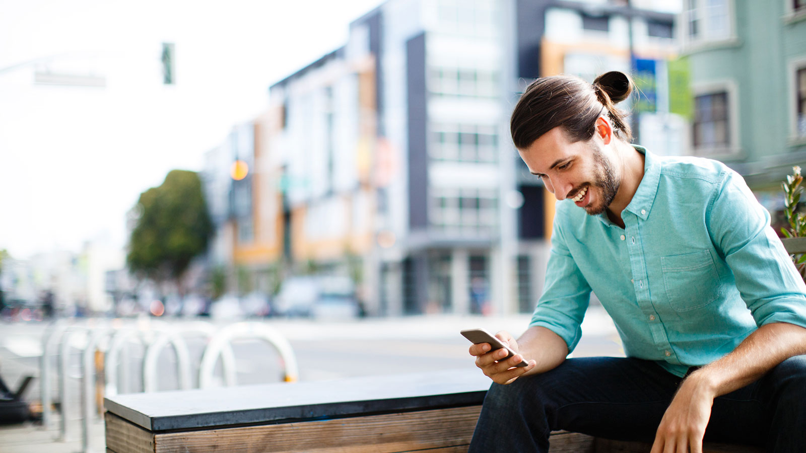 Person sitting on bench using phone